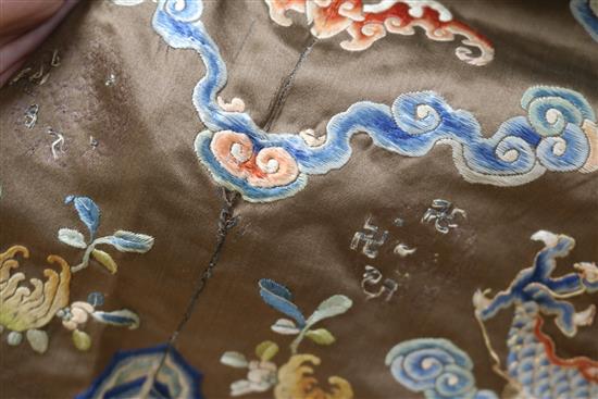 A Chinese black ground polychrome silk embroidered robe (a.f.)